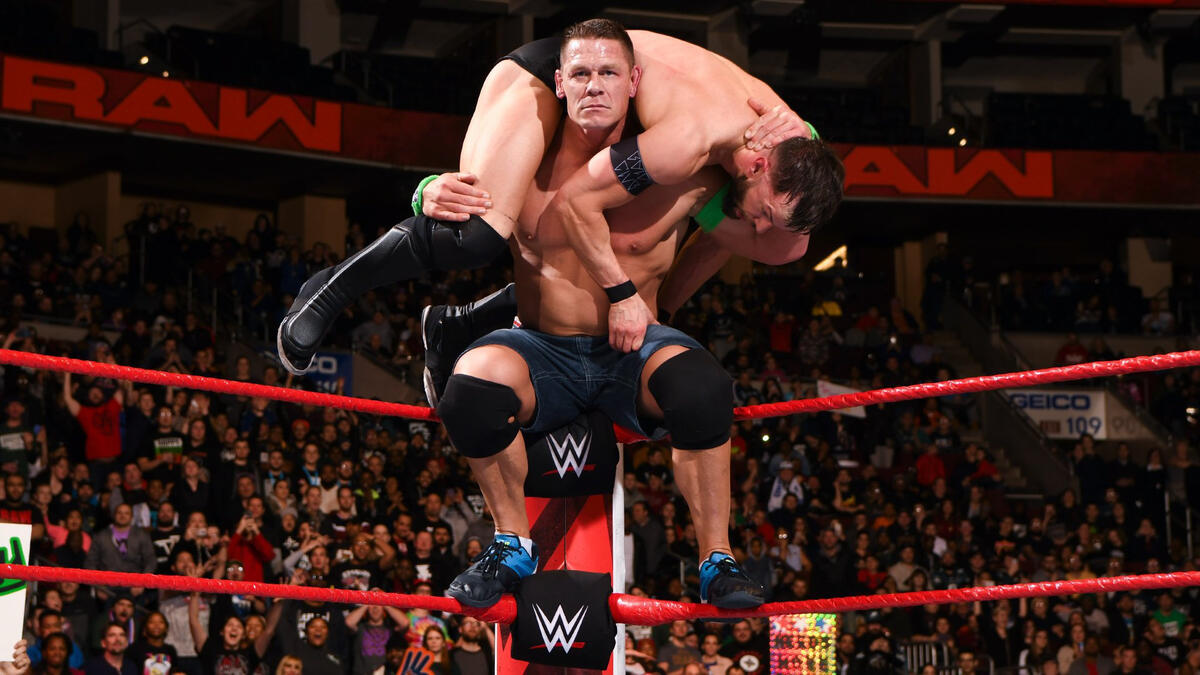 Cena lifts Bálor up...