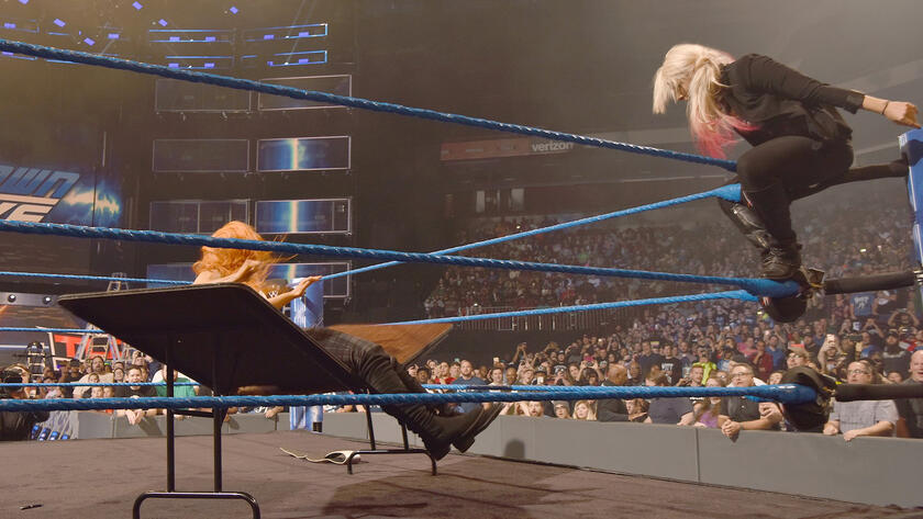 Bliss sends Becky through a table!