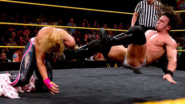 NXT Champion Adrian Neville dropkicks Tyler Breeze