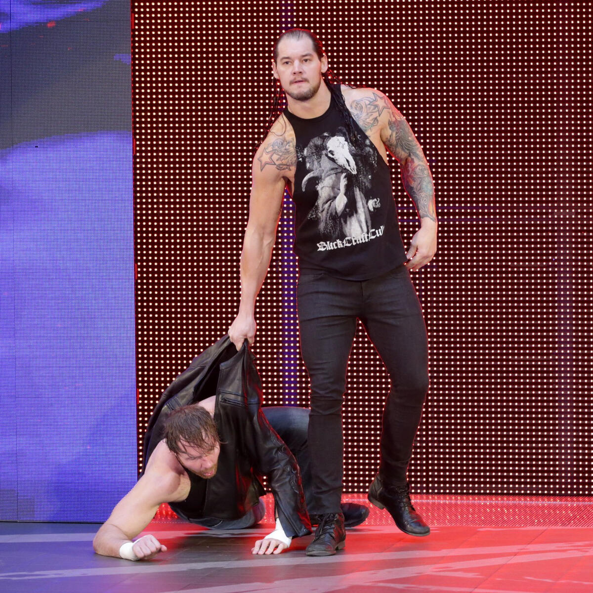 Baron Corbin drags Ambrose out onto the stage.