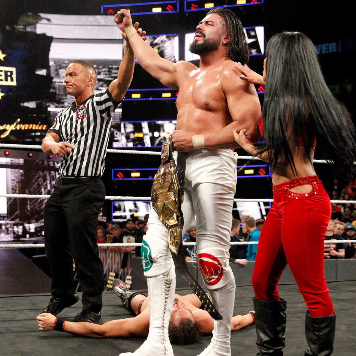 After hitting the hammerlock DDT on Gargano, Almas and Vega celebrate his NXT Championship victory.