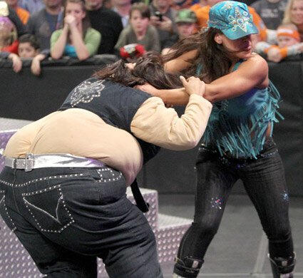 Layla is helpless against Mickie's furious assault.