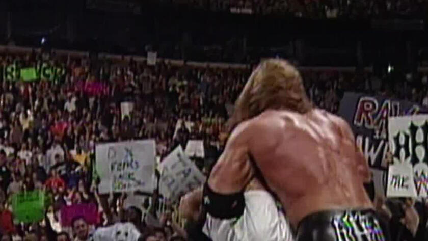 Triple H delivers a vicious Pedigree to Mankind on top of the announce  table: Raw, January 10, 2000 | WWE