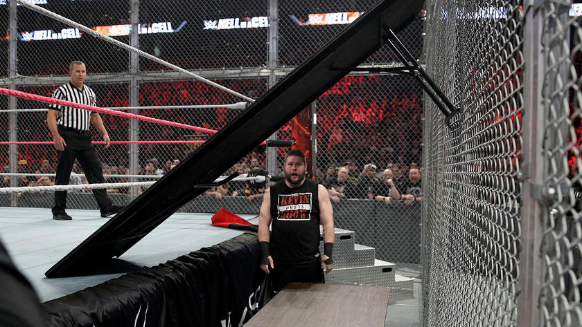 With malice toward Rollins on his mind, Owens sets up tables inside the Cell. 