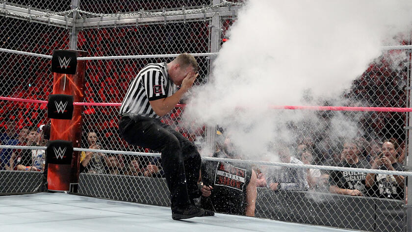 The WWE Universal Champion discharges a fire extinguisher in the official's face.