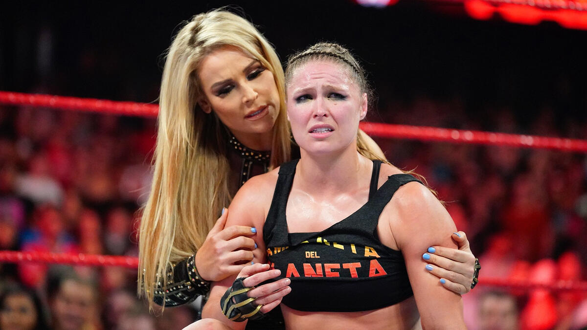 Natalya helps Ronda Rousey leave the arena following The Bella Twins ...