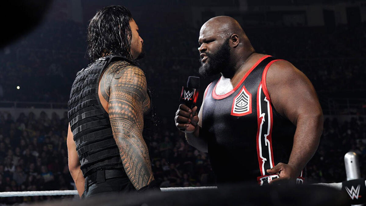 Roman Reigns Spears a returning Mark Henry through the barricade ...