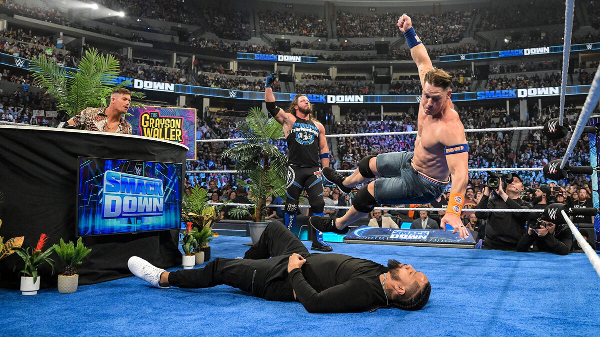 AJ Styles helps John Cena repel an attack by Jimmy Uso and Solo Sikoa